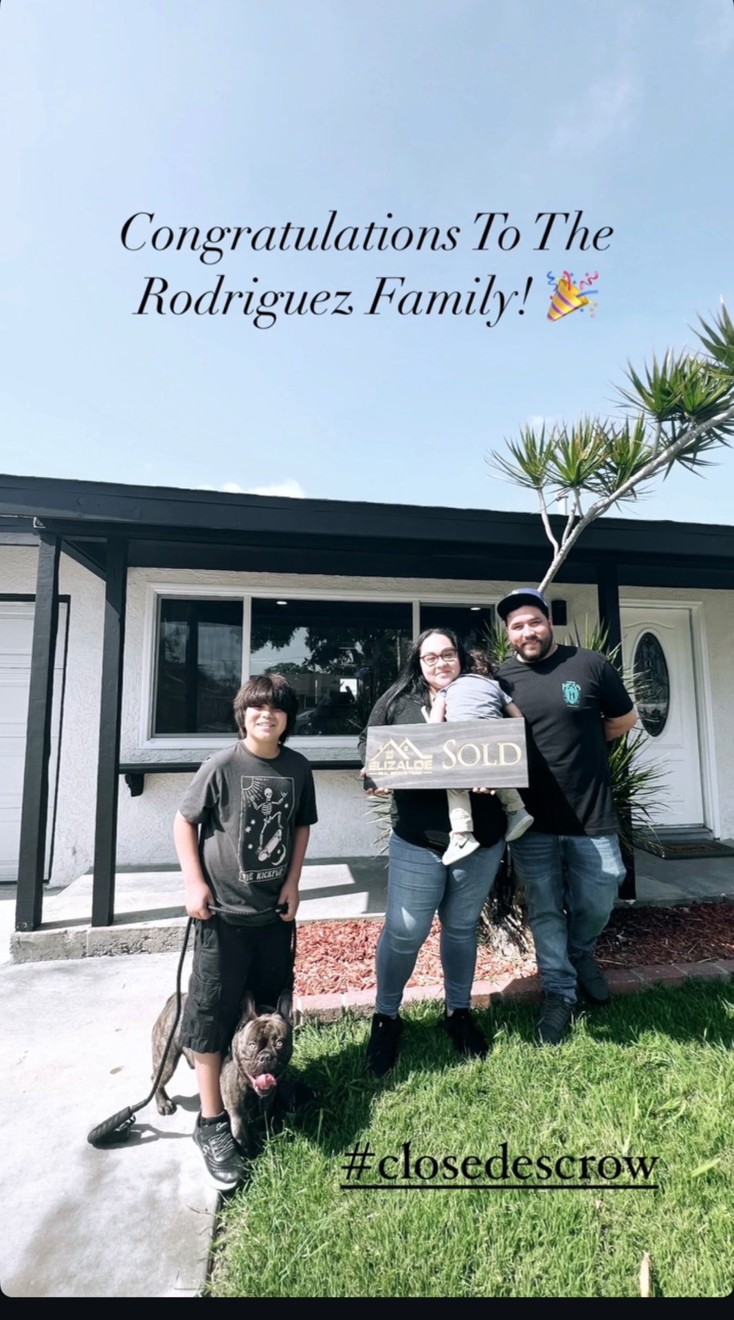 Clients celebrating with the sold sign on closing day